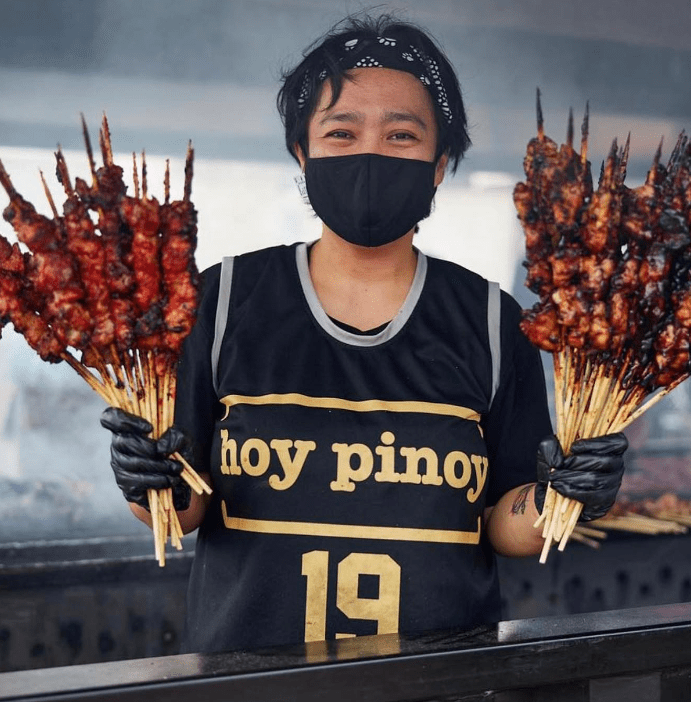 Man posing with cooked kebabs