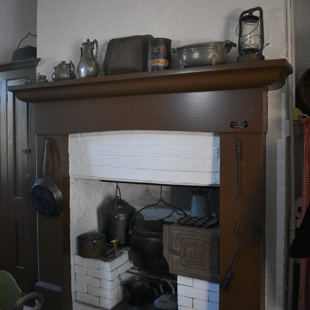 fire place with old cooking utensils