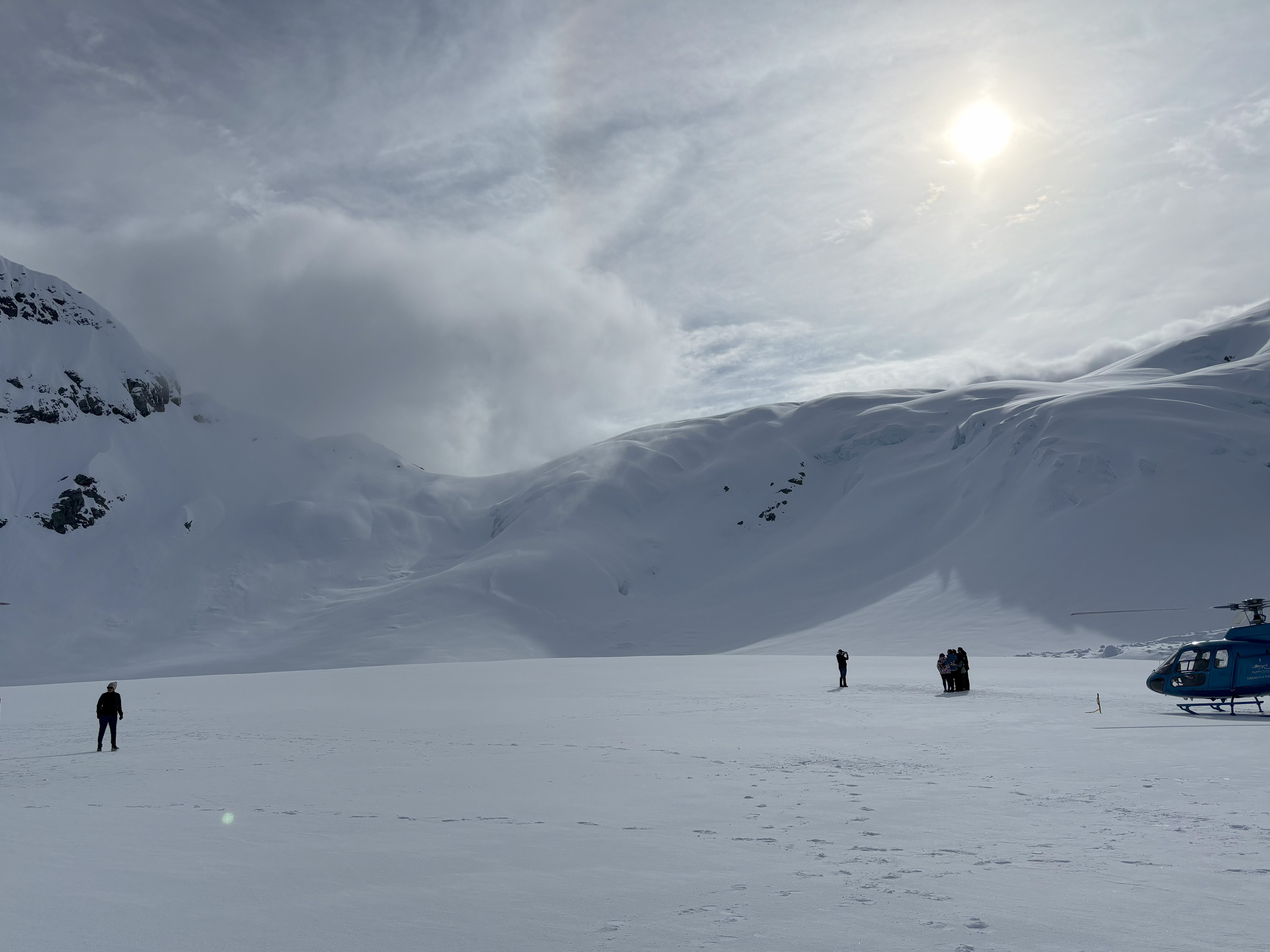 people standing in snowy mountains