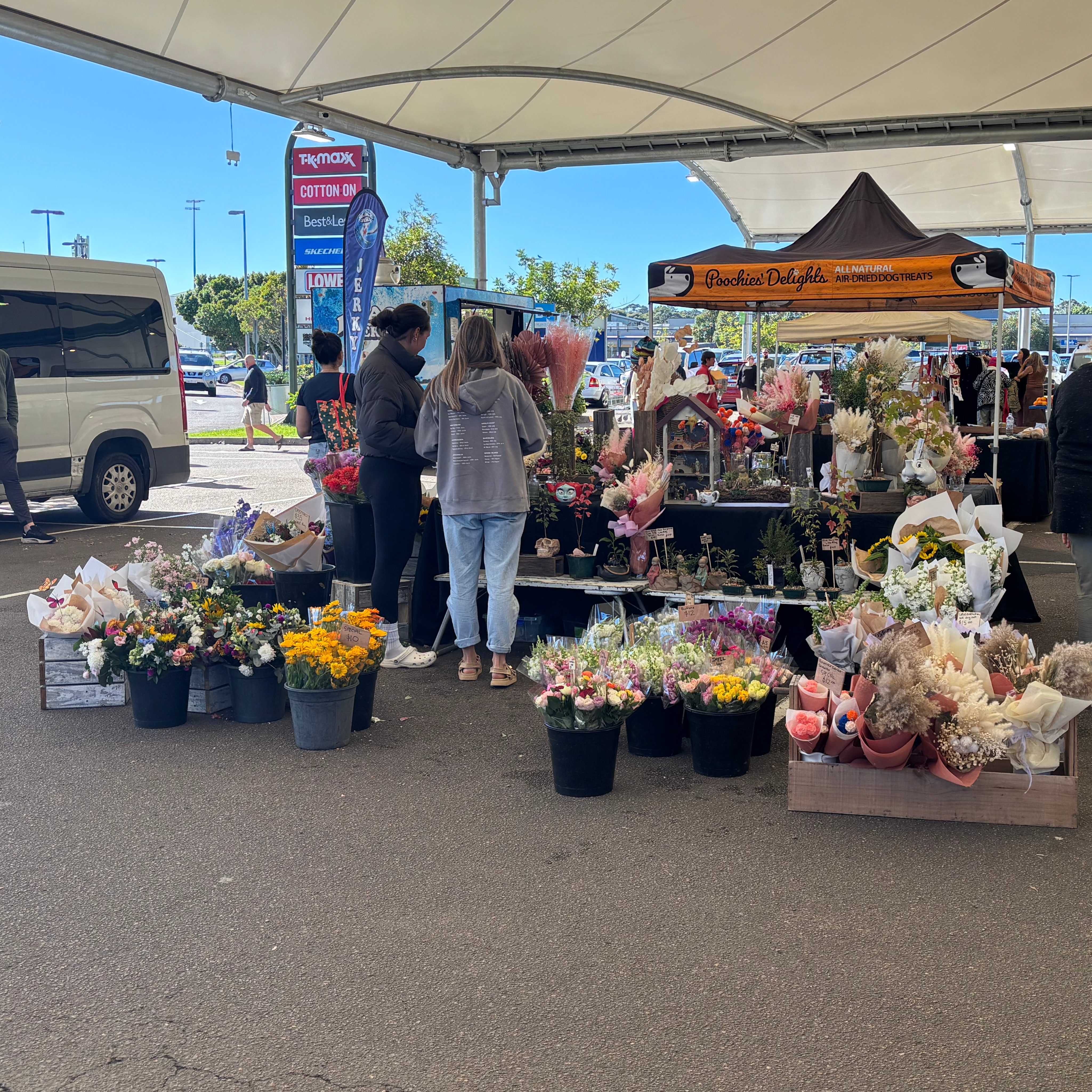 customers looking at flower bouquet market stall