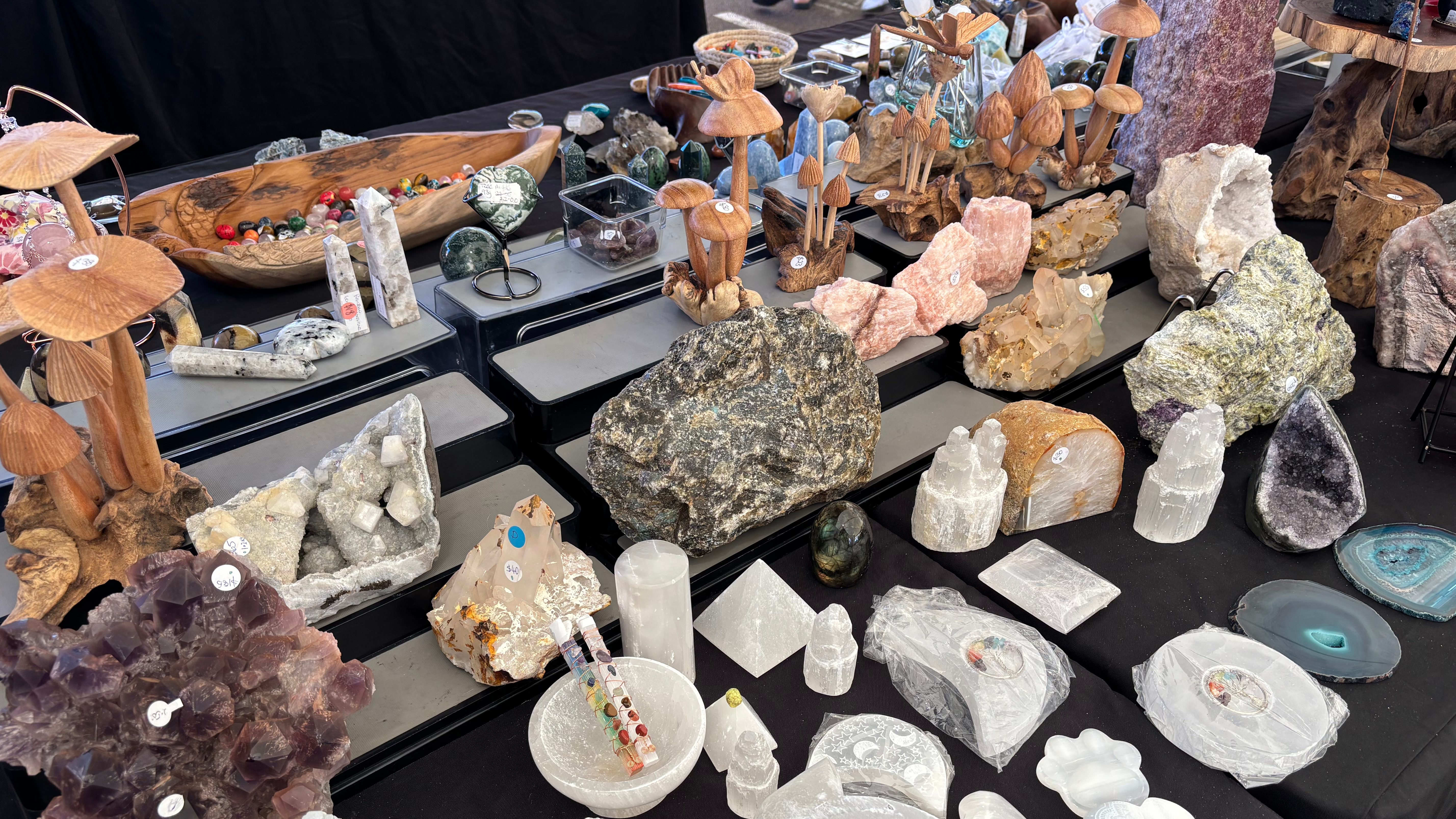 market stall of crystals and carved wooden statues
