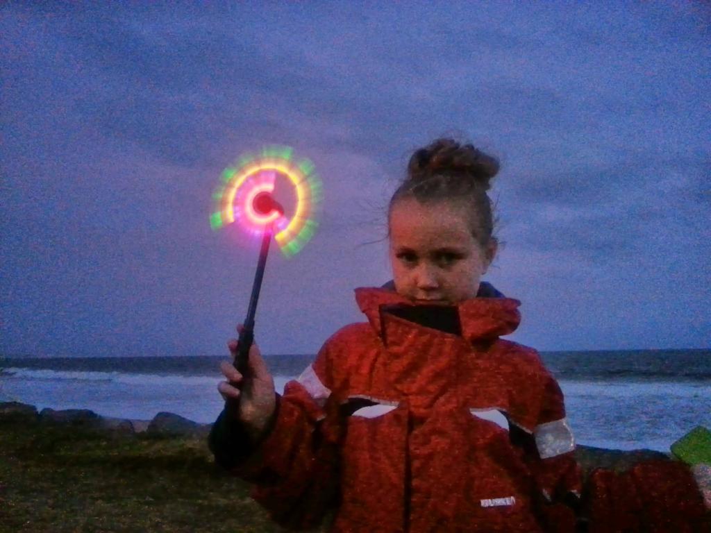 young girl in high-vis jacket with glow stick
