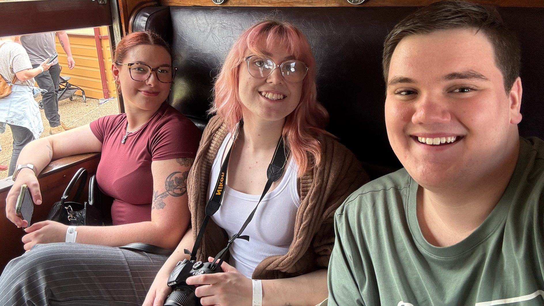 three people smiling at camera